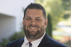 Man in a blue suit smiles